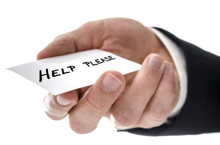 Closeup of a business man handing  card with Help please written on it. Isolated over white...