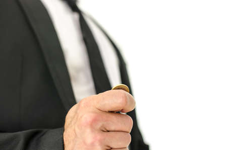 Closeup  of businessman hand flipping  a coin. Isolated over white background.の写真素材