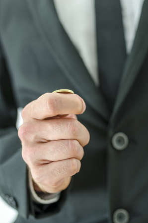 Closeup  of businessman hand tossing a coin.の写真素材