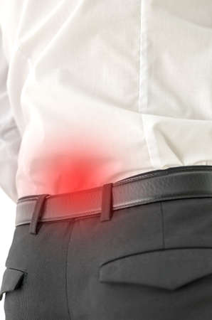 Closeup of acute lower back pain. Red spot indicating the pain.