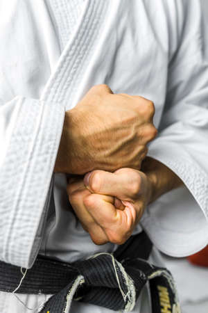 Closeup of male karate fighter making fists with his hands.の写真素材