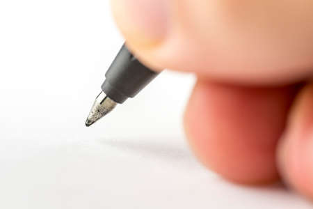 Macro shot of male hand writing.の写真素材