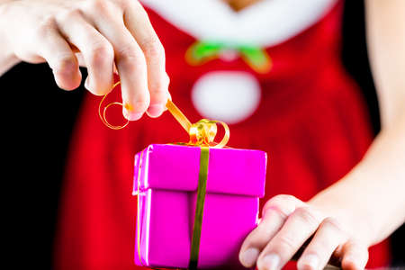 Closeup of opening christmas present.
