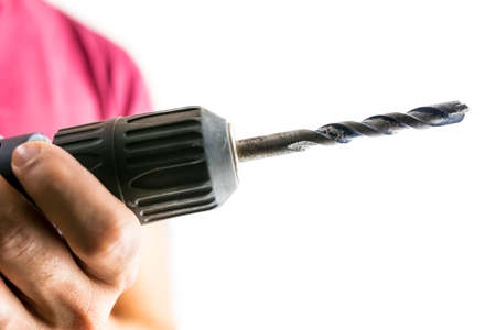 Closeup of man holding drilling machine. Isolated over white .の写真素材