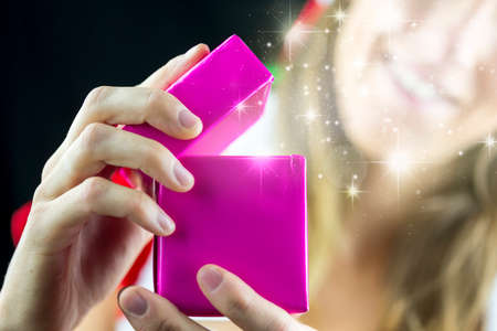 Girl opening magical christmas present.