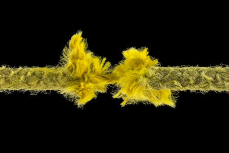 Yellow rope just before ripping apart. Uncertainty concept.の写真素材