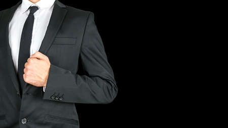 Front view of businessman torso in elegant business suit. Isolated over black background. Empty space ready for your text.の写真素材