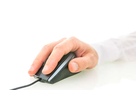 Closeup of male hand using computer mouse. Over white background. Empty space ready for your text.の写真素材