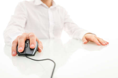 Using computer mouse on white desk の写真素材