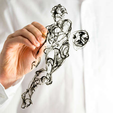 Hand drawing football player kicking ball on virtual white board.の写真素材