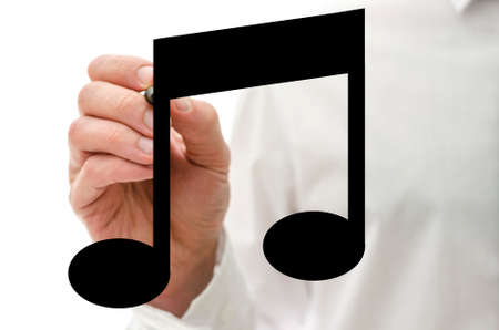 Closeup of male hand drawing musical note on virtual screen.の写真素材