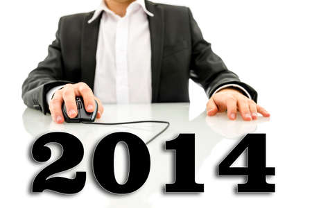 Virtual 2014 sign attached to computer mouse cable used by businessman.の写真素材