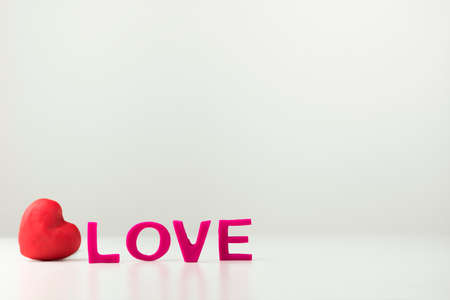 Valentines Day greeting card background with a small red romantic heartの写真素材