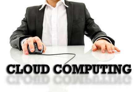 Cloud computing text on a reflective surface with a businessman using a wired computer mouse in the...