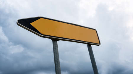 Blank yellow road sign with left pointing arrow.の写真素材