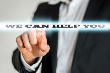Male customer service representative activating a We can help you button on virtual screen.の写真素材