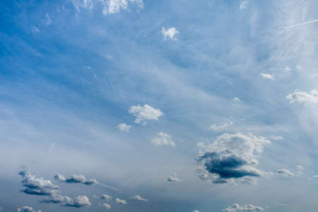 Beautiful cloudscape with fluffy clouds in early evening.