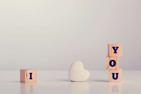 I love you on wooden blocks with copyspace for your message, vintage effect toned image.の写真素材