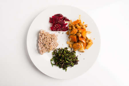 Top view of nutritious macrobiotic plate - buckwheat, seaweed with chives, chickpeas with vegetables and redd beets.の写真素材