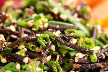Closeup of healthy rich in calcium hiziki seaweed with chives and sesame seeds.の写真素材