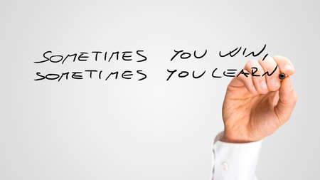 Handwritten of Sometimes You Win Sometimes You Learn Passage. Isolated on Gray Background.の写真素材