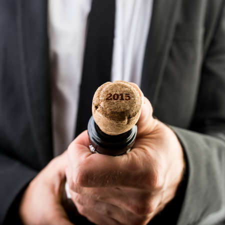 Close up Businessman Opening Bottle of Wine with 2015 Text on the Cork.の写真素材