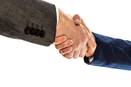 Businesspeople, a man and woman in jackets, shaking hands to conclude a business arrangement, in partnership, greeting or congratulations, close up view of their hands over white.の写真素材