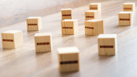 Conceptual Small Wooden Cubes on Top of a Table with Business Texts. Captured in Close up.の写真素材