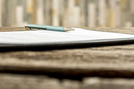 Low angle view of a pen lying on a contract, legal paper or document.の写真素材