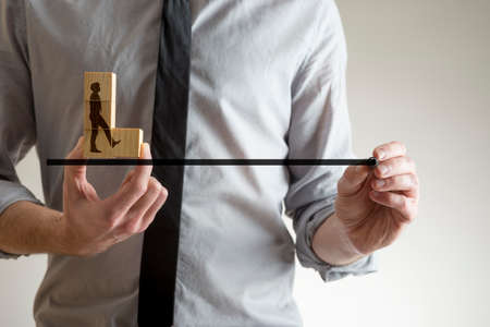 Man drawing the line with a marker pen for the silhouette of a businessman, conceptual of partnership and teamwork.の写真素材