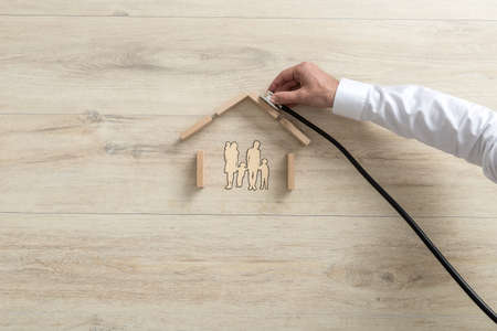 High-angle conceptual close-up of the hand of an expert holding a stethoscope on the roof of a...