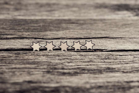 Retro style image of a five stars on a rustic wooden boards. Perfect  rating concept.の写真素材