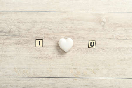 Romantic I Love You message on wood with a central white ornamental heart and copy space below for a Valentine greeting to your sweetheart.の写真素材