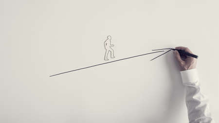 Paper silhouette cutout of a man and male hand drawing upward arrow over white background, retro toned image.の写真素材