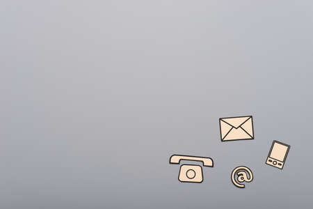 Contact and communication icons, phone, at sign, mobile and mail, on gray background with copy space.の写真素材