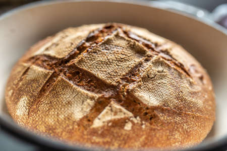 Freshly baked home made bread in a clay pot.