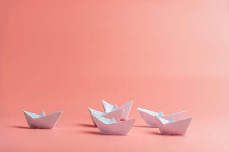 Six origami paper boats over pink background.の写真素材