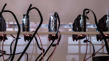 Five crypto currency graphic cards mining rig in a conceptual image of modern technology.