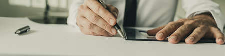 Wide view image of an architect working on a project drawing using a ruler and pencil.の写真素材