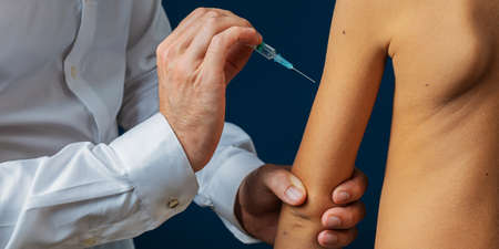 Closeup of a pediatric doctor vaccinating a toddler child.の写真素材