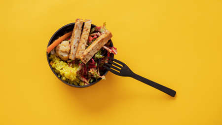 Top view of healthy and delicious buddha bowl with rice, salad, tofu and vegetables.の写真素材