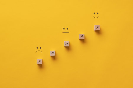 Arrows pointing from a sad expression towards a happy one - conceptual image of personal growth and aspiration.の写真素材