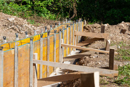 Construction framework of wooden panels ready for cement outside in construction site.の写真素材