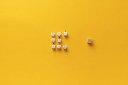 Wooden cube standing out of a crowd of other cubes in a conceptual image of personal vision, identity and uniqueness.の写真素材