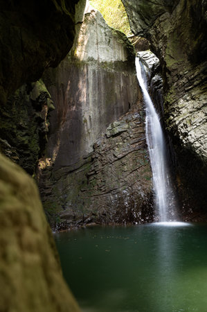 Slap kozjak in slovenia, europe falling in a pool of green water in an open top cave.の写真素材