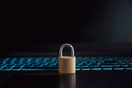 Golden padlock placed on an open black laptop computer in a conceptual image of online data and password protection.の写真素材
