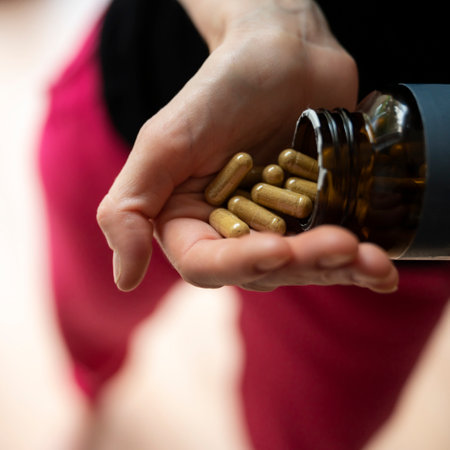 Closeup view of female hand full of dietary supplement pills of vitamins and essential nutrients.の写真素材