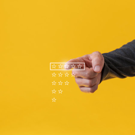Male finger pressing a five star evaluation point on a scale shining on virtual interface. Over bright yellow background.の写真素材