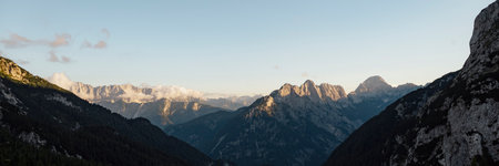 Wide view image of beautiful high rock mountains with peaks lit by the setting sun.の写真素材