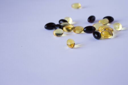 astaxanthin and fish oil. Gel capsules on white backgroundの写真素材